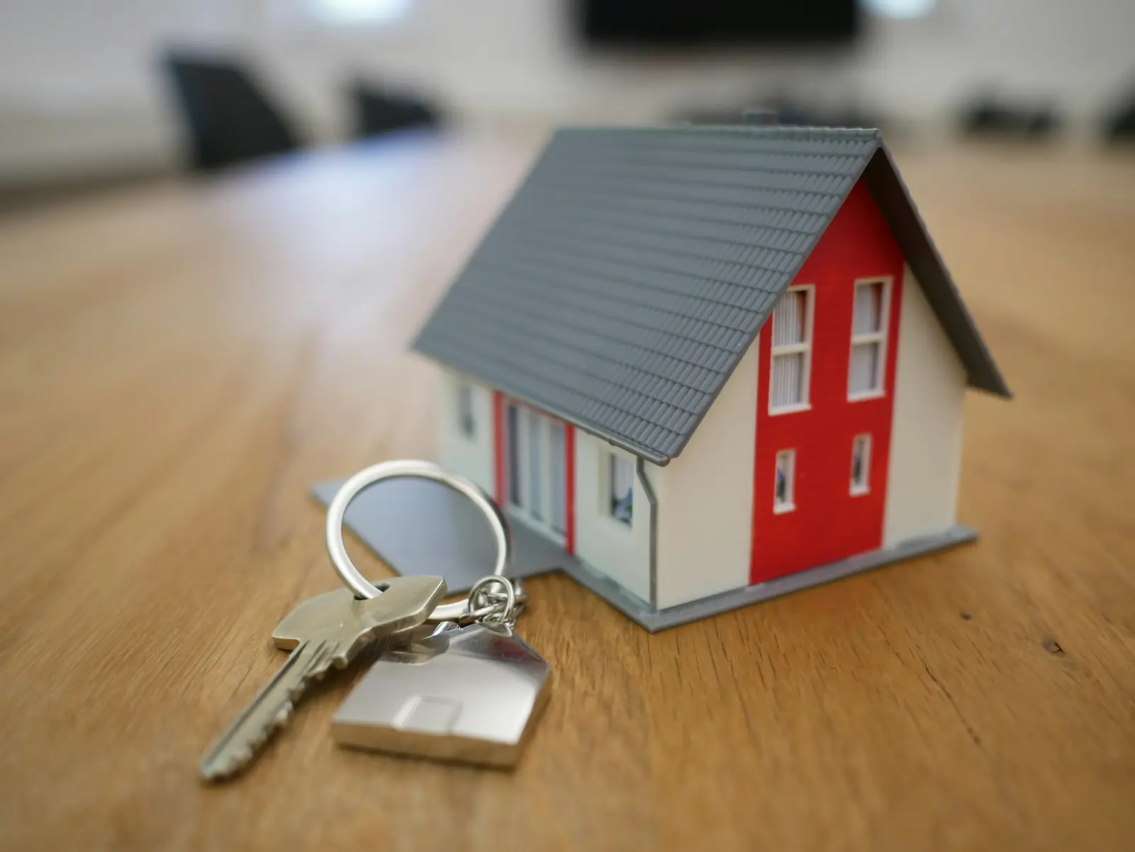 House keys next to a model home